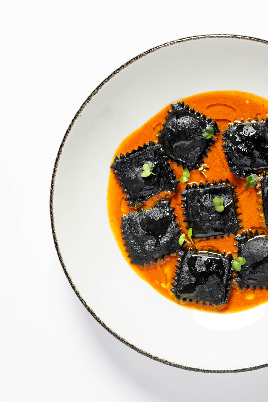 Ravioli with cuttlefish ink and salmon